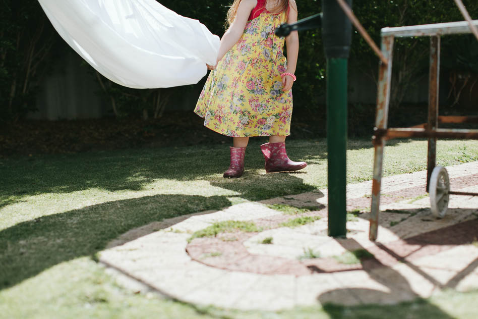 girl playing in backyard hills hoist, krystle ricci photographer