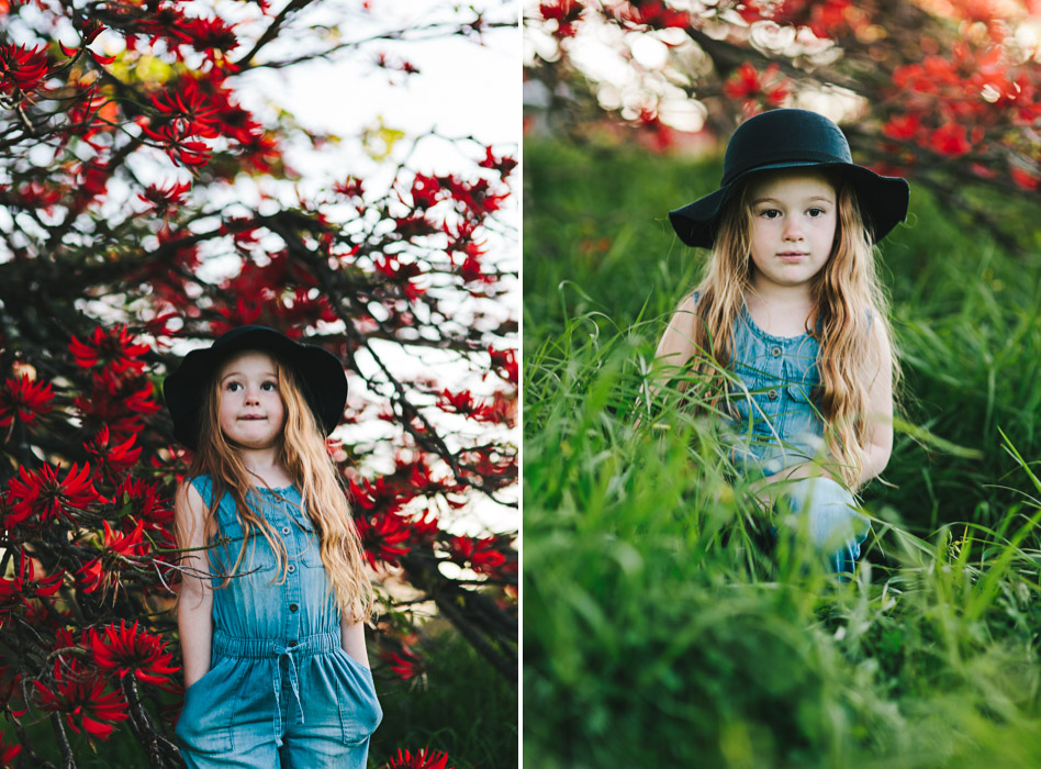 girl in felt hat, standing in front of flame tree, Brachychiton acerifolius