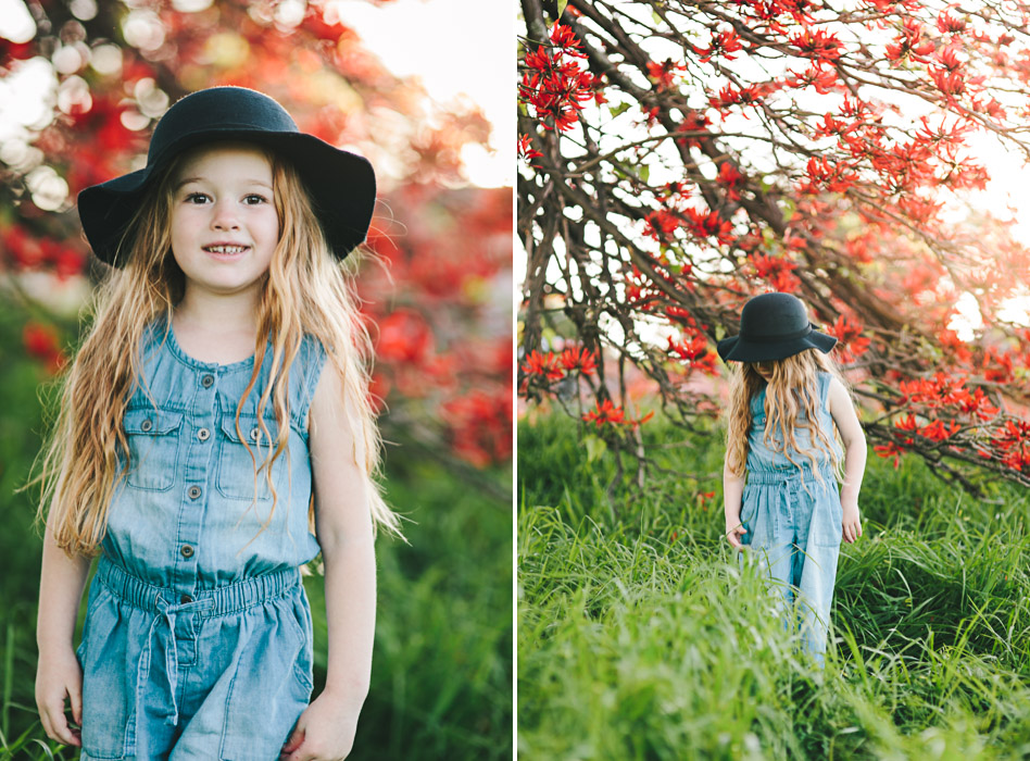 girls wearing black felt bowler hat, standing under flame tree, Brachychiton acerifolius