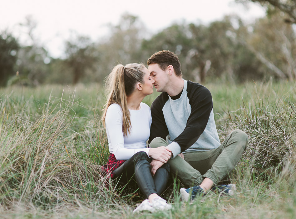 engaged couple kissing