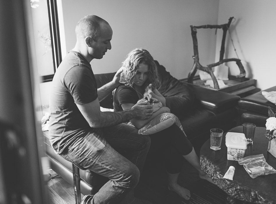 parents feeding baby