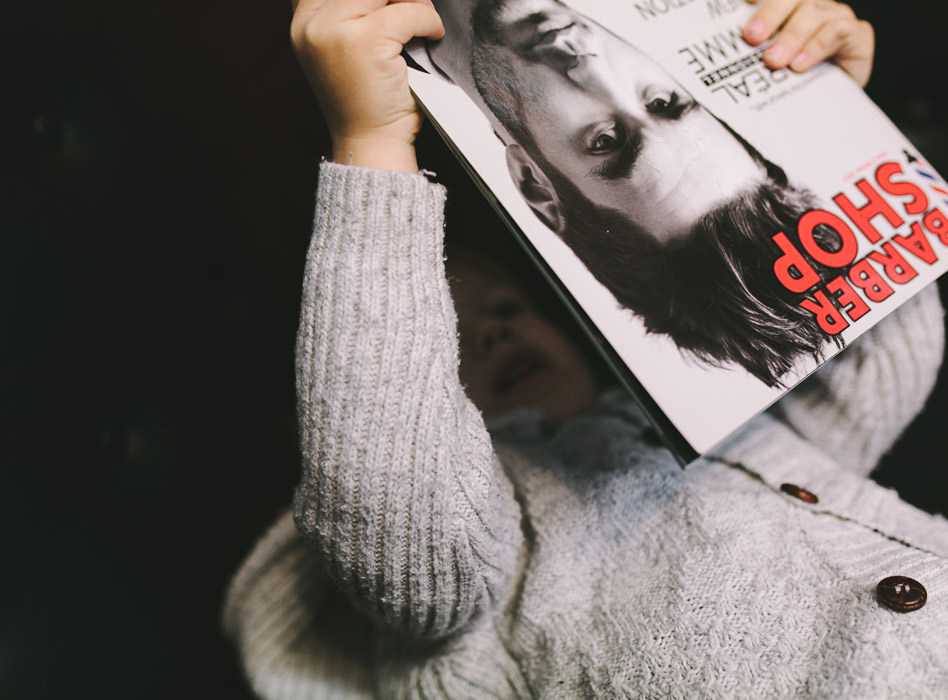 boy reading barber shop magazine