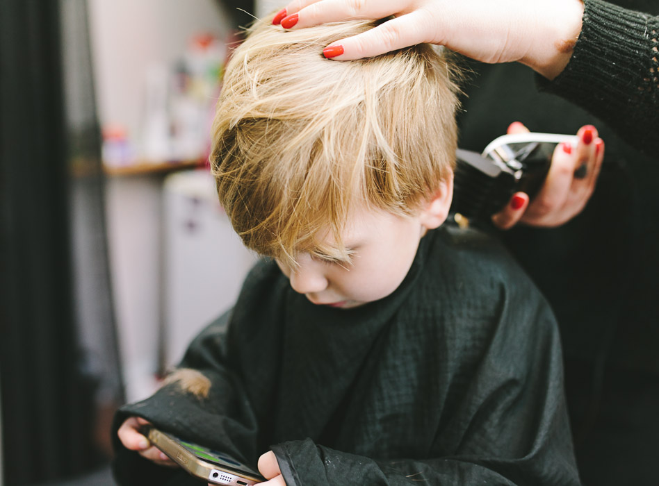 hairdresser cutting toddlers hair