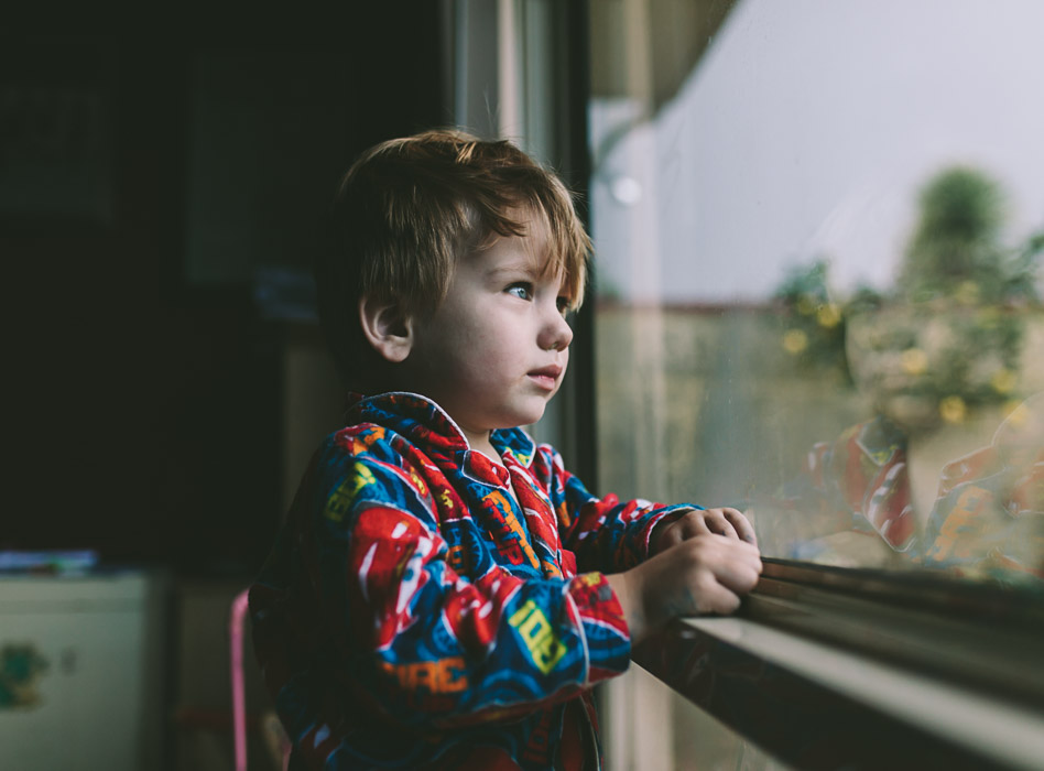 boy looking out window