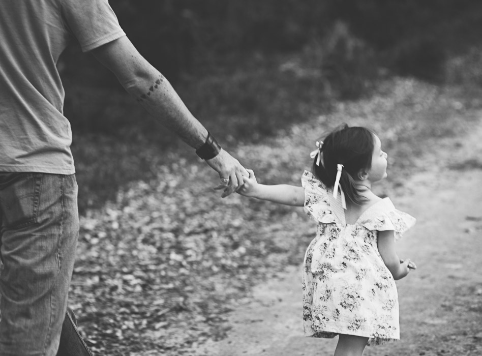 toddler holds dads hand