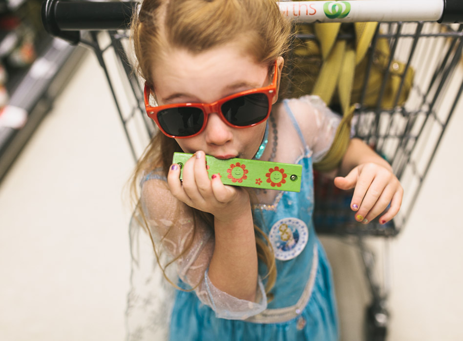 girl playing green harmonica