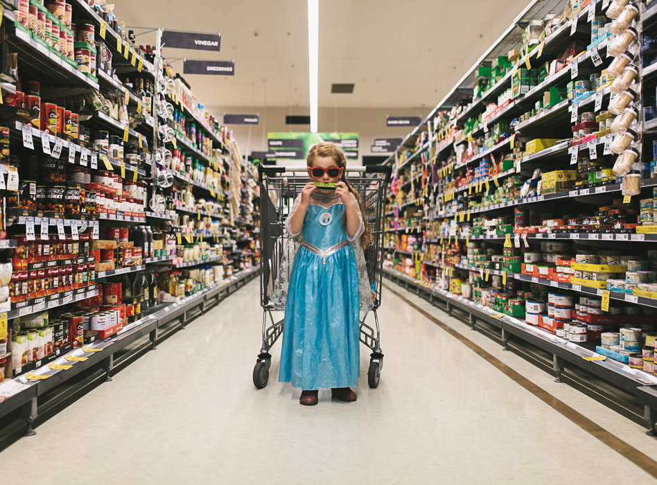 girl playing harmonica in aisle of woolworths shopping centre