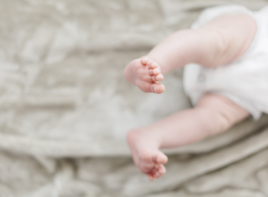 perth newborn photographer baby on bed