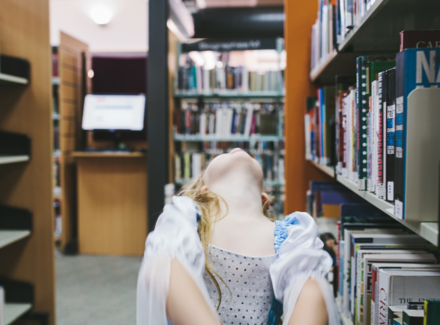 girl dressed ad darth vader at the library