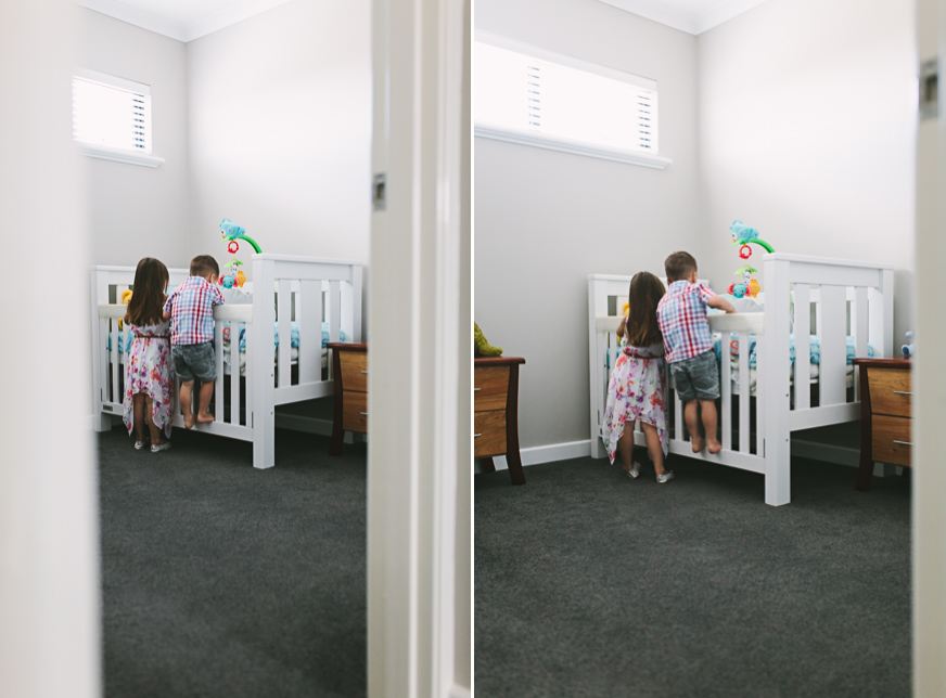 children looking into crib