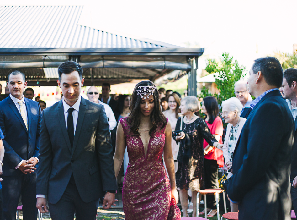 bride and groom walk down aisle