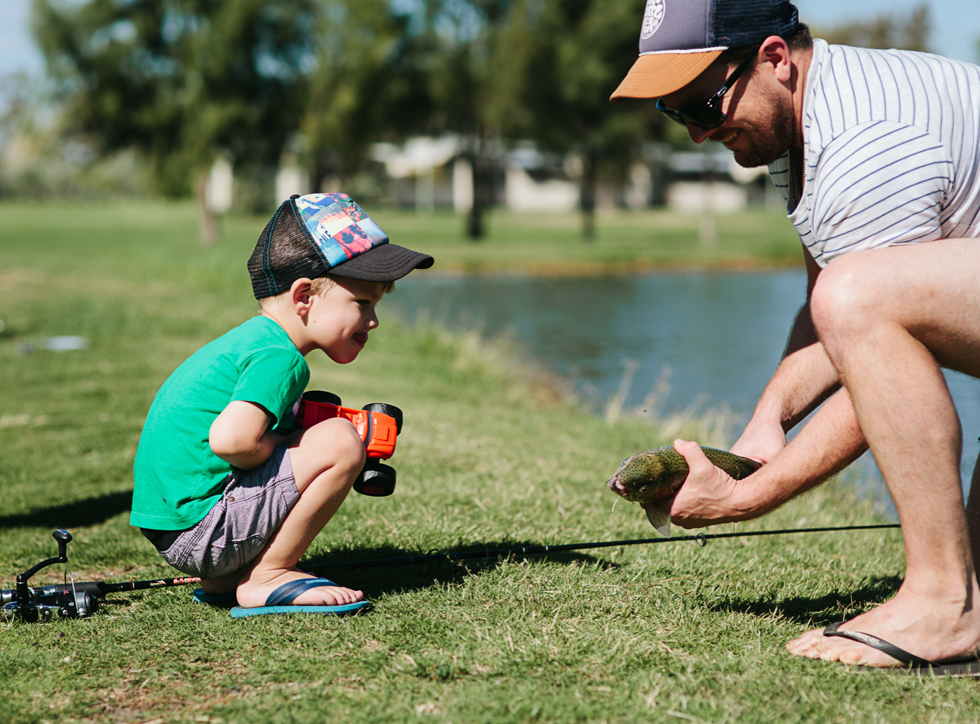 father shows son fish
