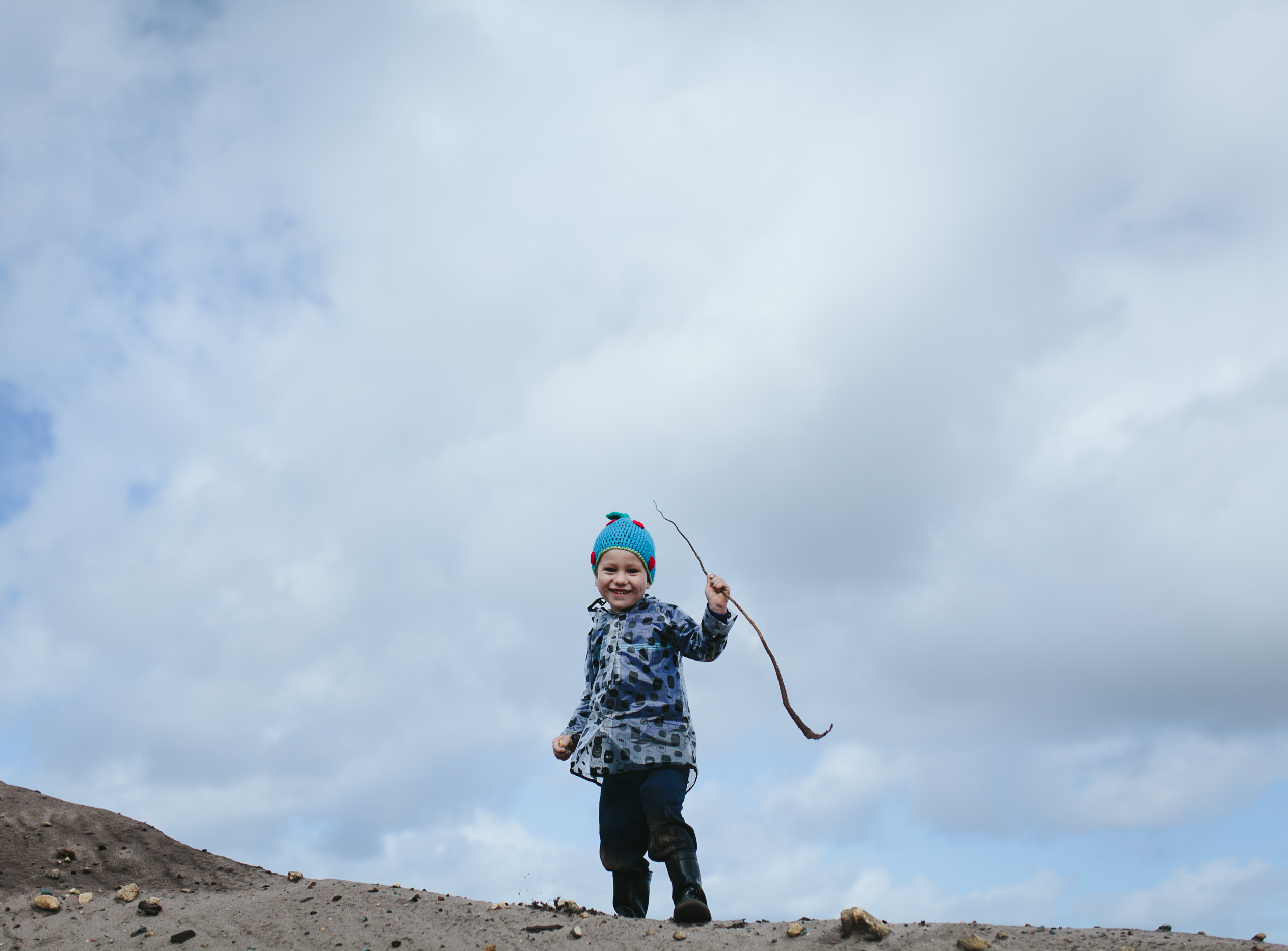 toddler reaches top of find hill