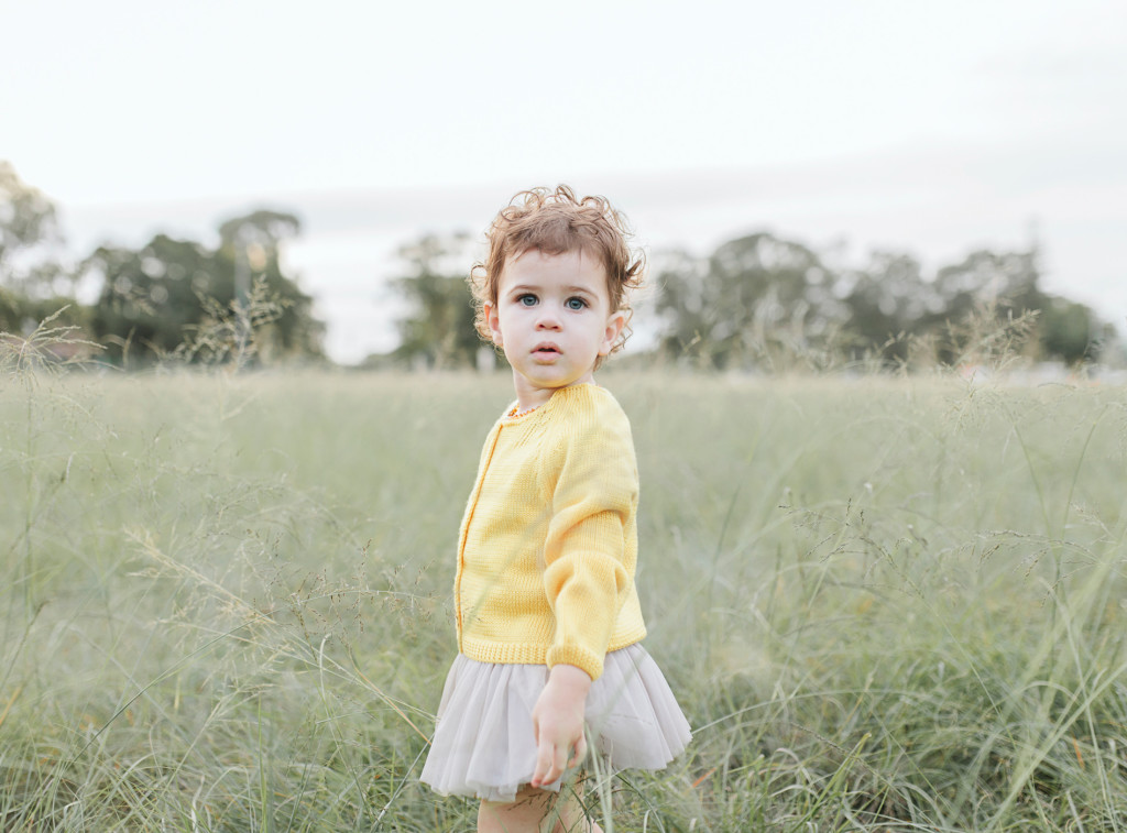 toddler stands in grass at perth winter photo shoot