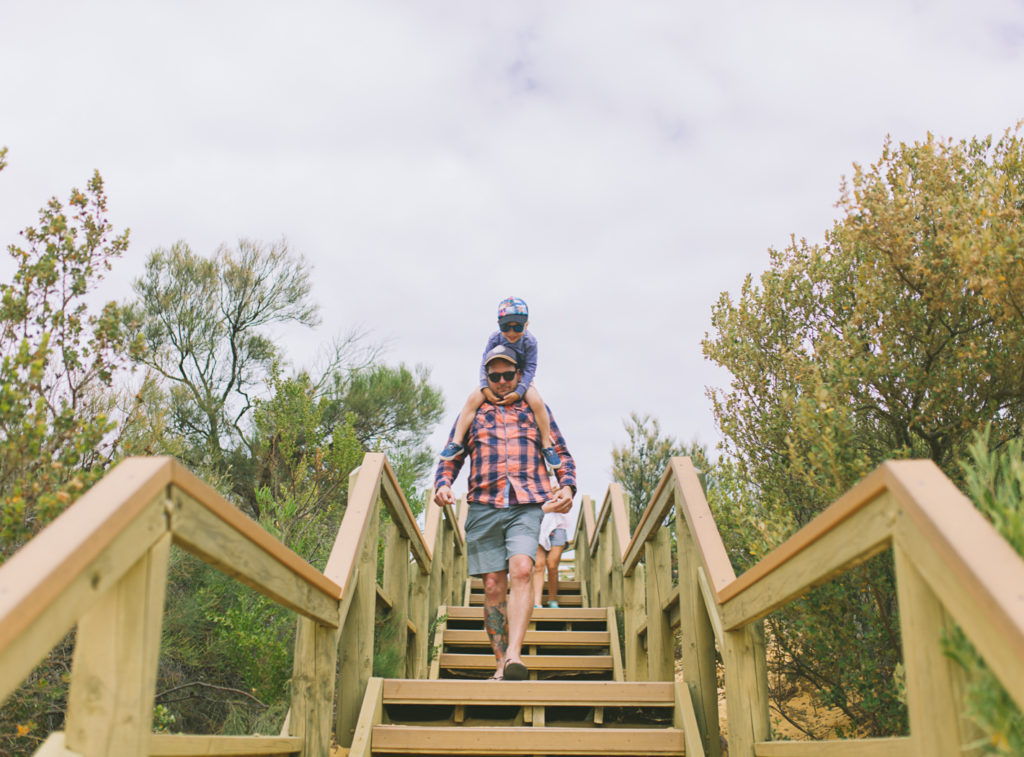 father and son walking on stairs