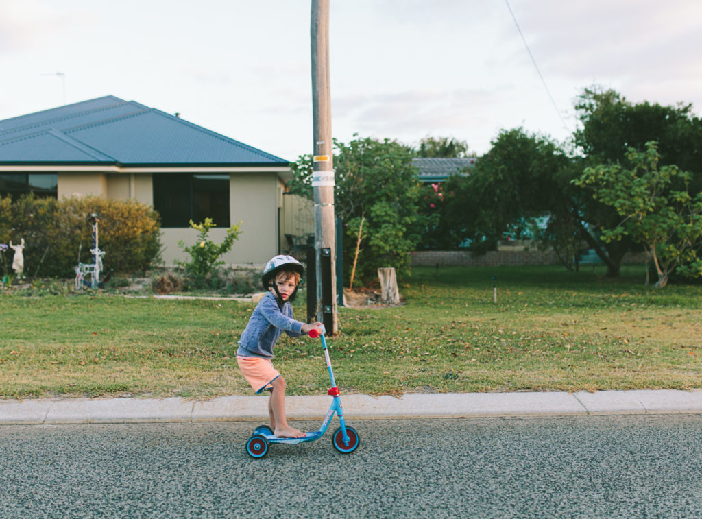 boy riding scooter in jurien bay