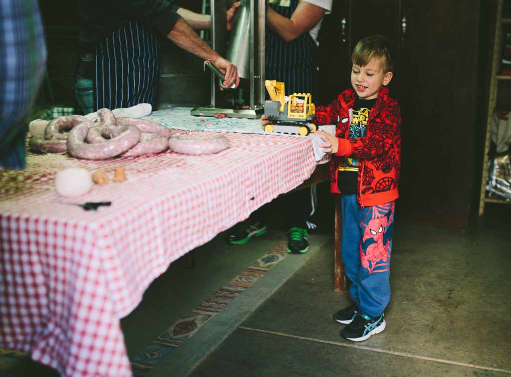 boy plays with toys on sausage making table