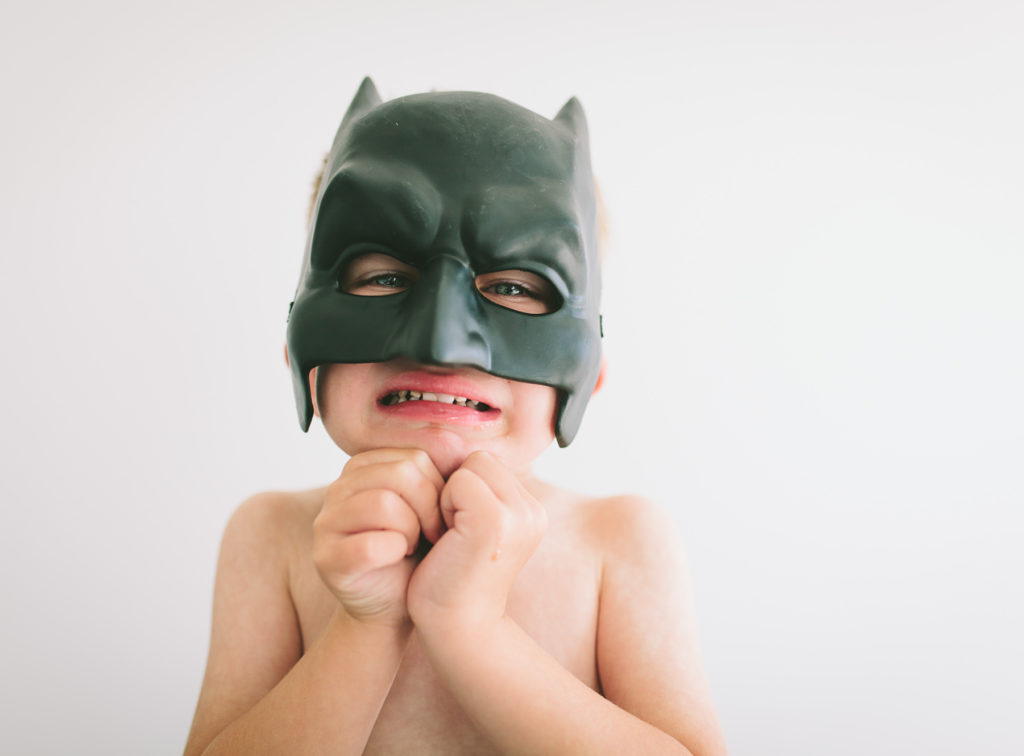 boy in batman mask crying