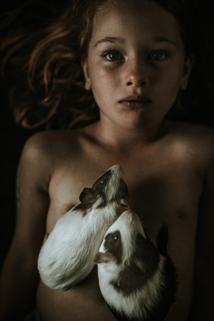 guinea pigs lying on child
