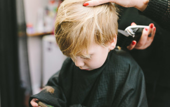 hairdresser cutting toddlers hair