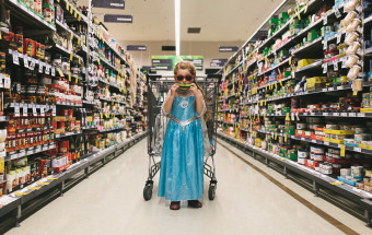 girl playing harmonica in aisle of woolworths shopping centre